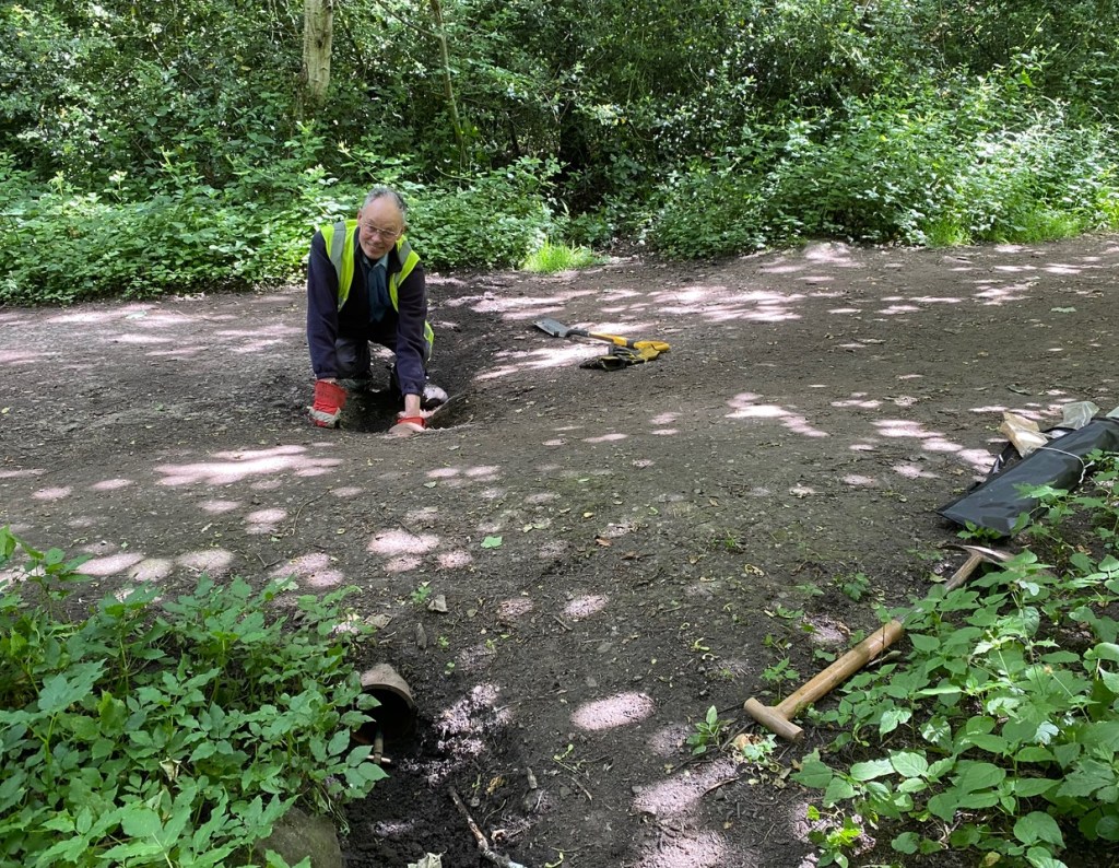 clearing a drainage pipe on Crag Lane, Ade Woods, Leeds 18th June 2022