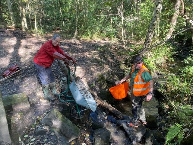 Friends of Adel Woods washing down equipment after working on Adel Pond on the 15th October 2023
