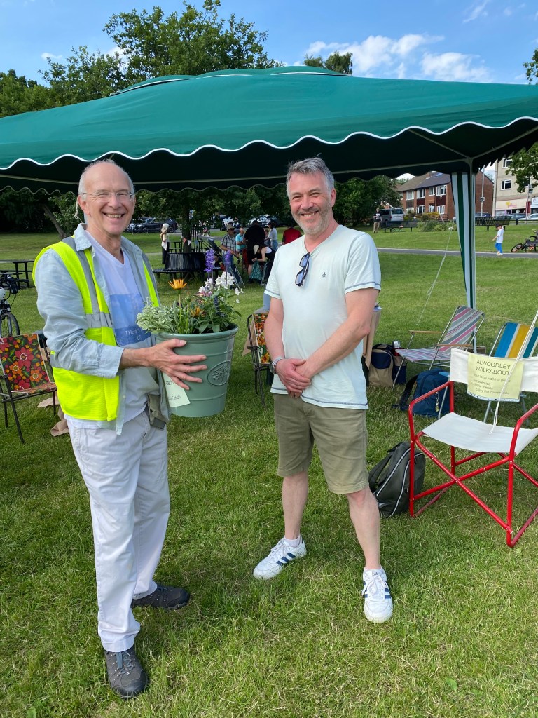 The Chair of Friends of Adel Woods presenting the raffle prize at the community picnic on 21st June 2026